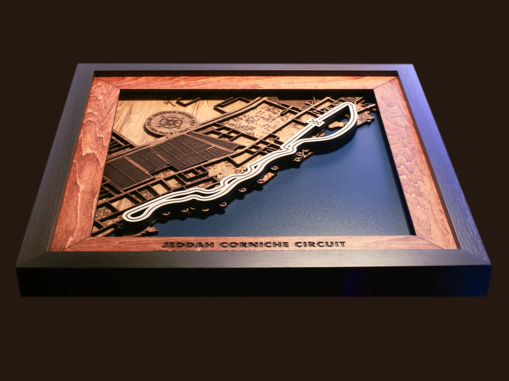 Close-up of the handcrafted layered wood construction and fine details of the Jeddah Corniche Circuit wall art.
