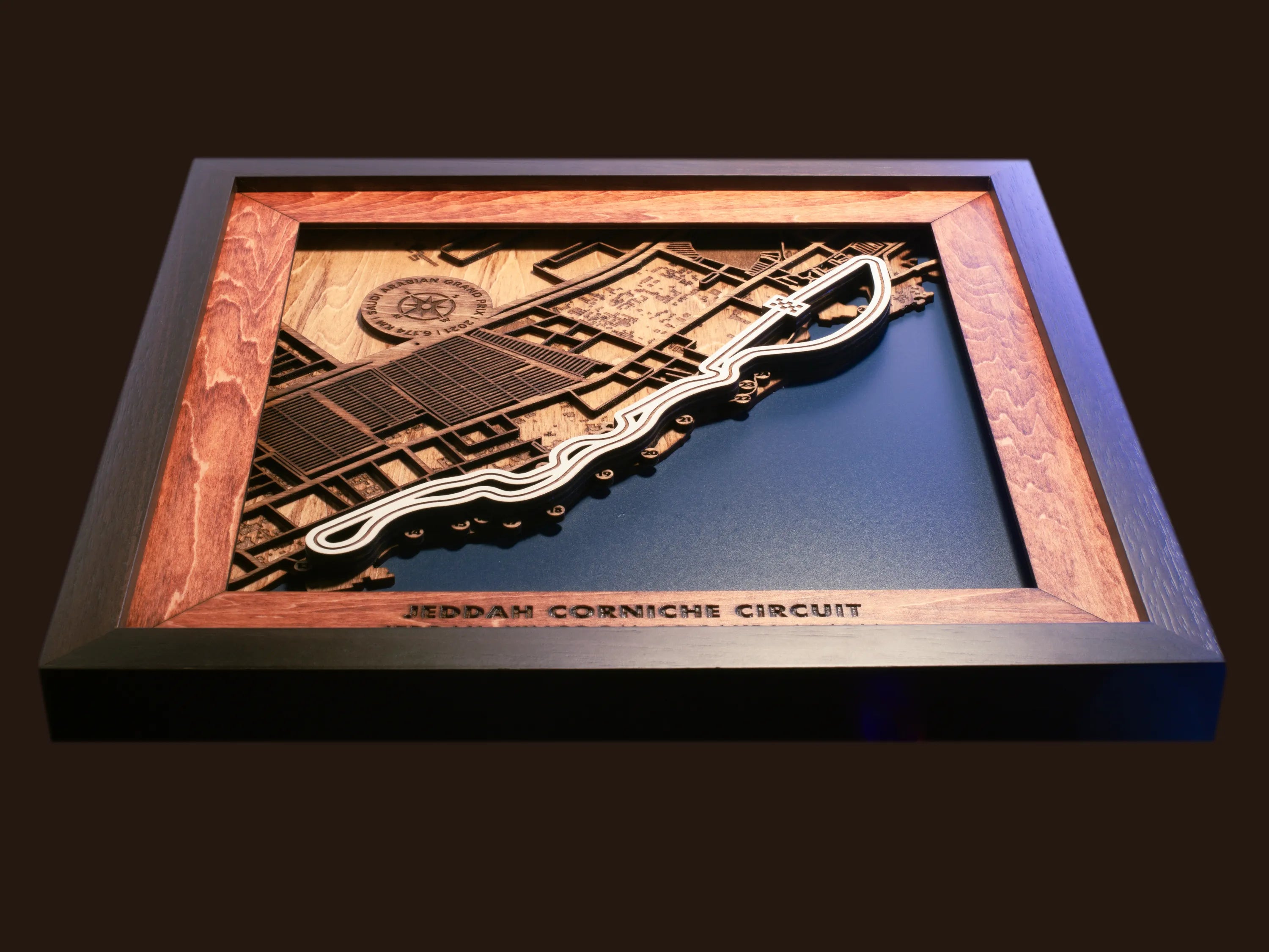 Close-up of the handcrafted layered wood construction and fine details of the Jeddah Corniche Circuit wall art.