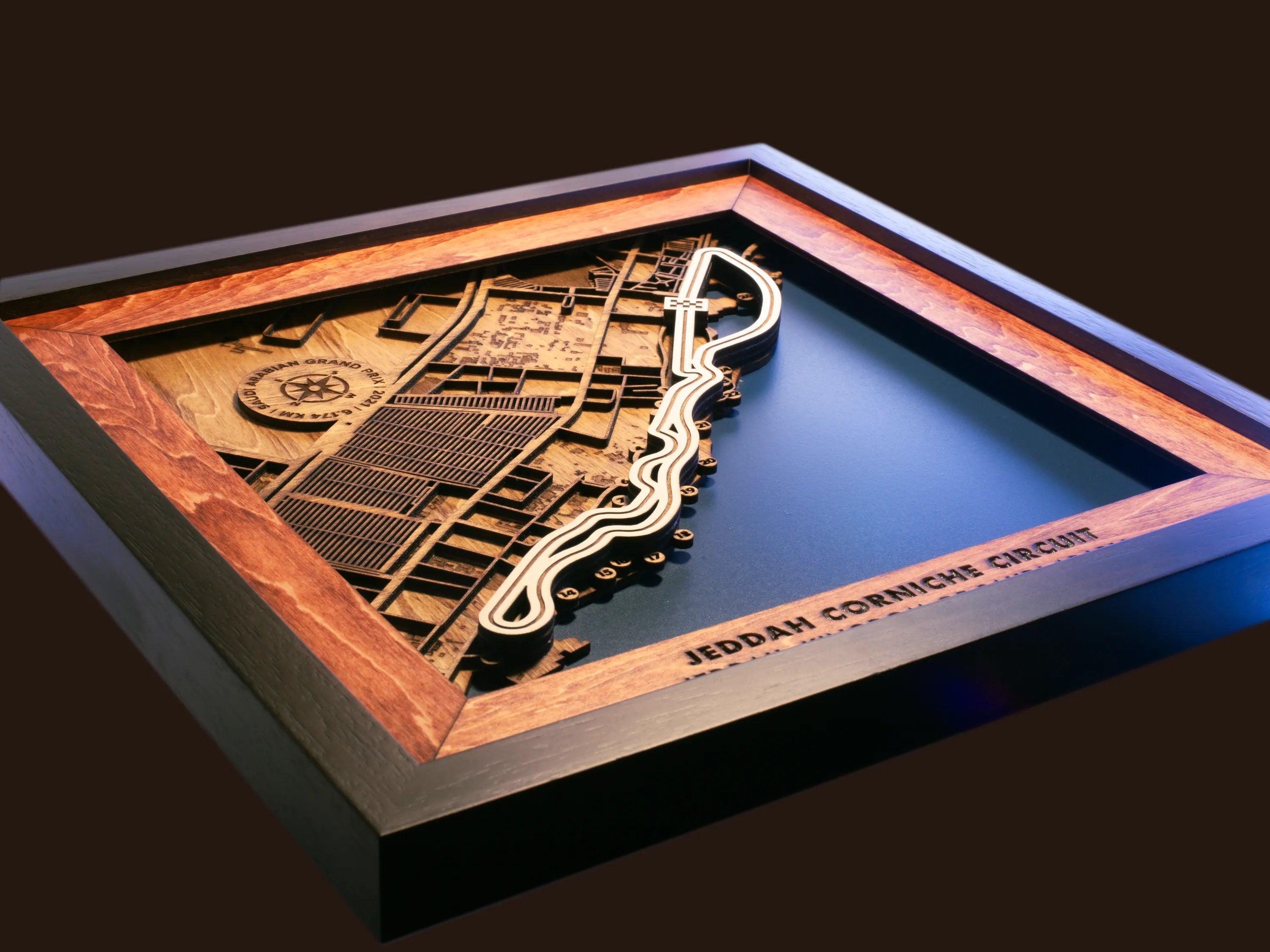 Close-up of the handcrafted layered wood construction and fine details of the Jeddah Corniche Circuit wall art.