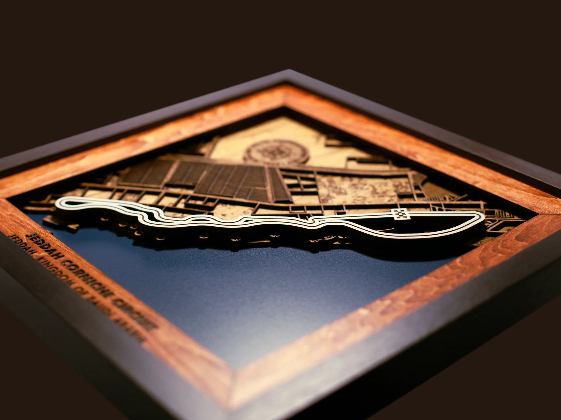 Close-up of the handcrafted layered wood construction and fine details of the Jeddah Corniche Circuit wall art.