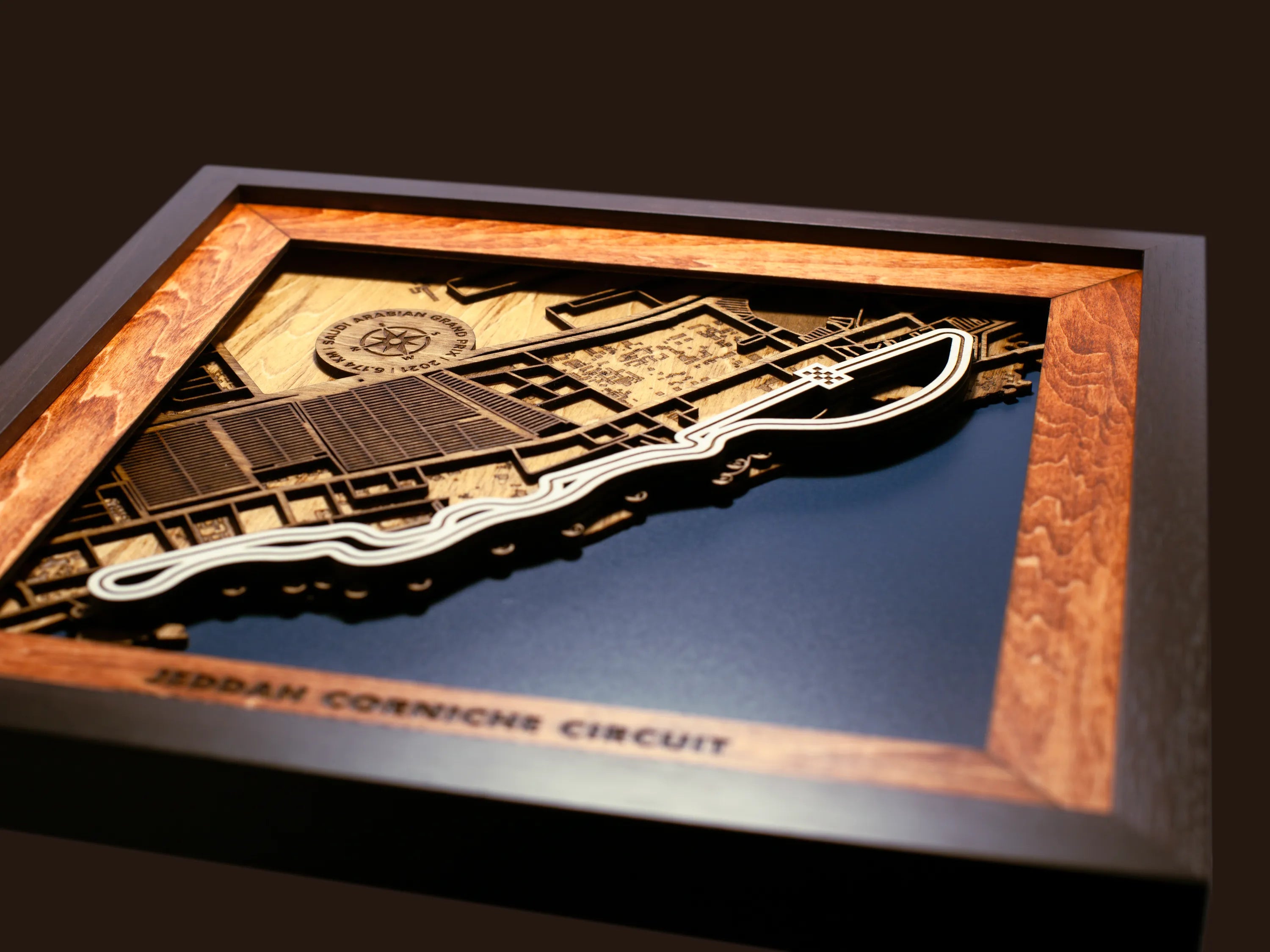 Close-up of the handcrafted layered wood construction and fine details of the Jeddah Corniche Circuit wall art.