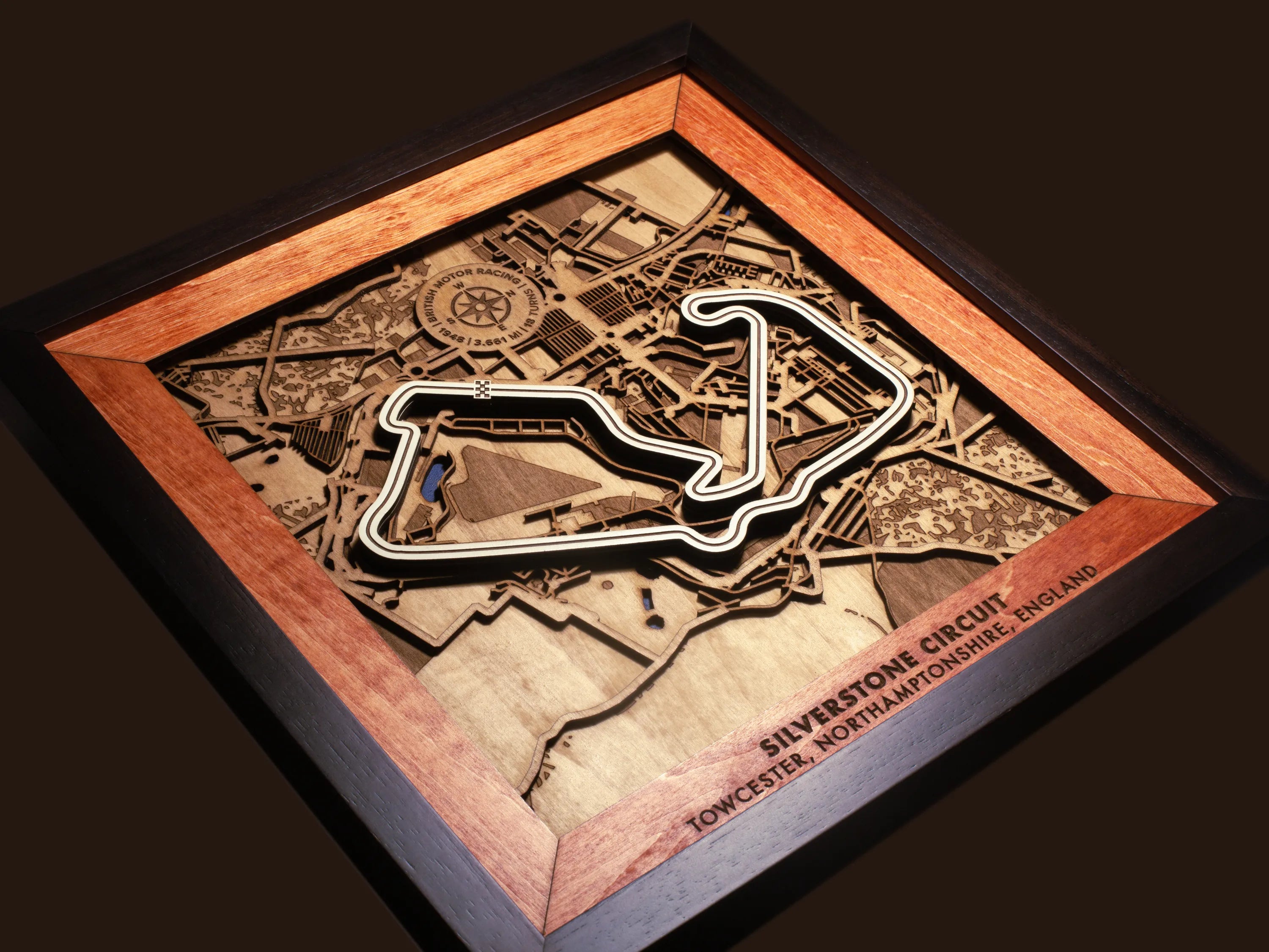 Close-up of the handcrafted layered wood construction and fine details of the Silverstone Circuit wall art.