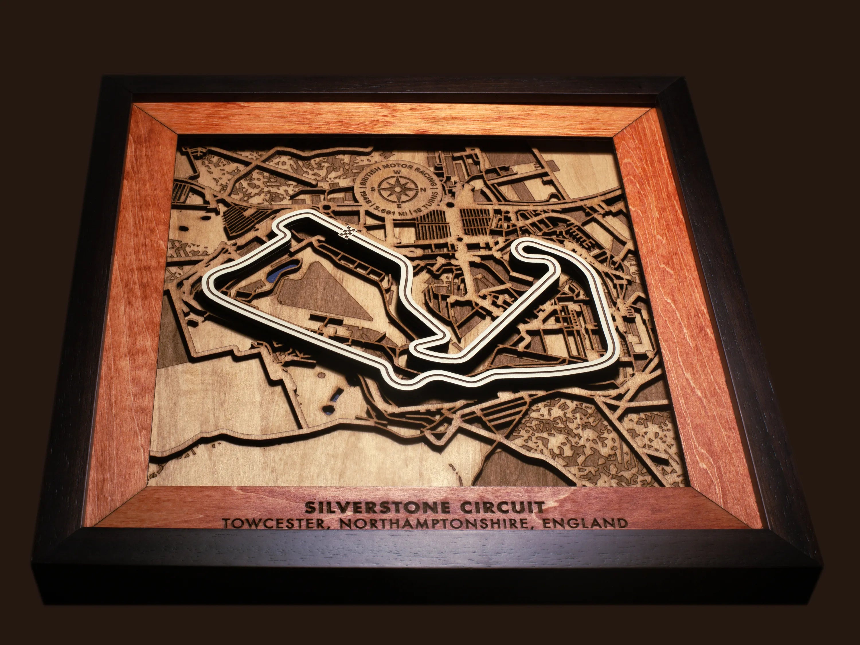 Close-up of the handcrafted layered wood construction and fine details of the Silverstone Circuit wall art.