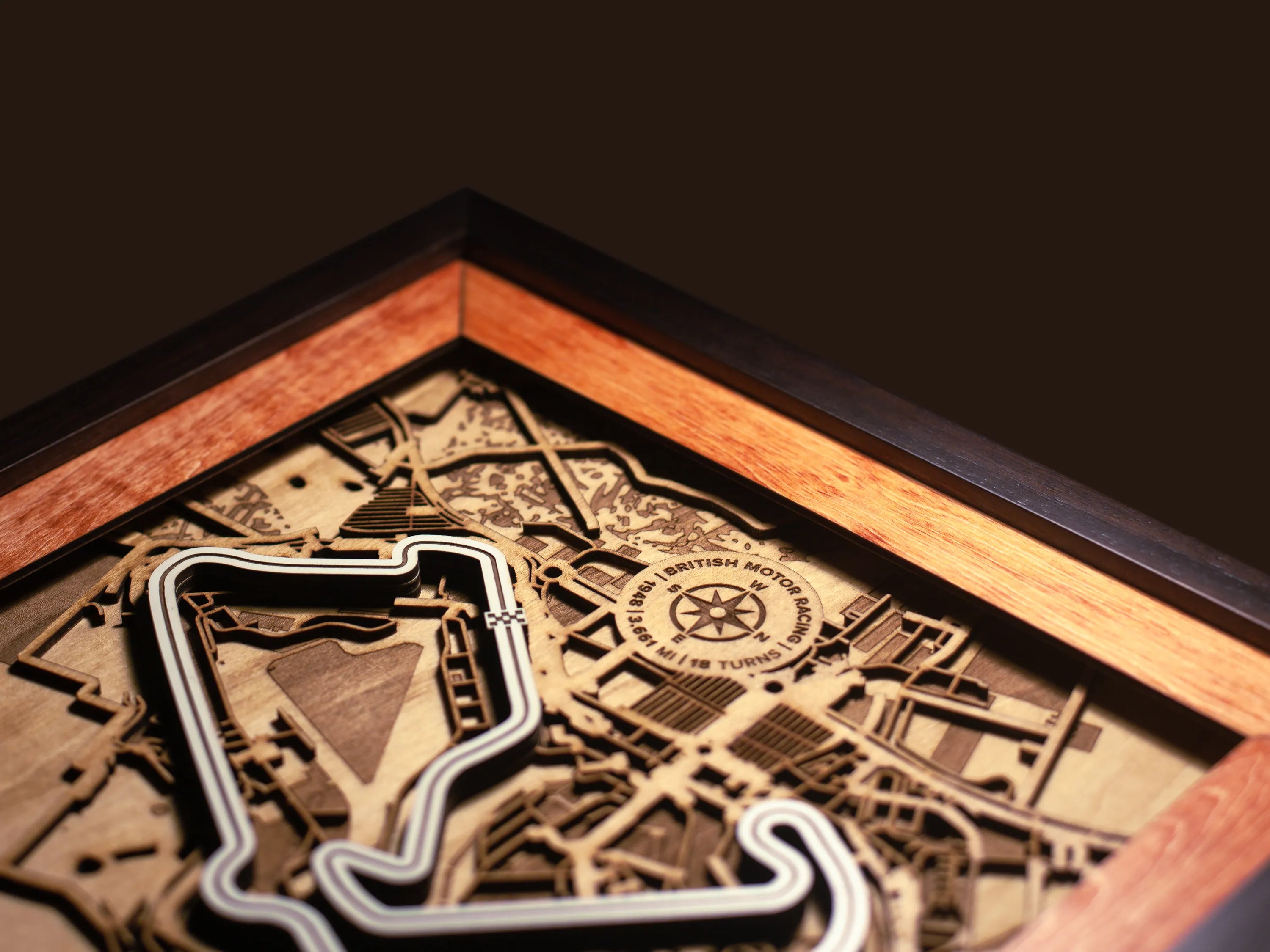 Close-up of the handcrafted layered wood construction and fine details of the Silverstone Circuit wall art.