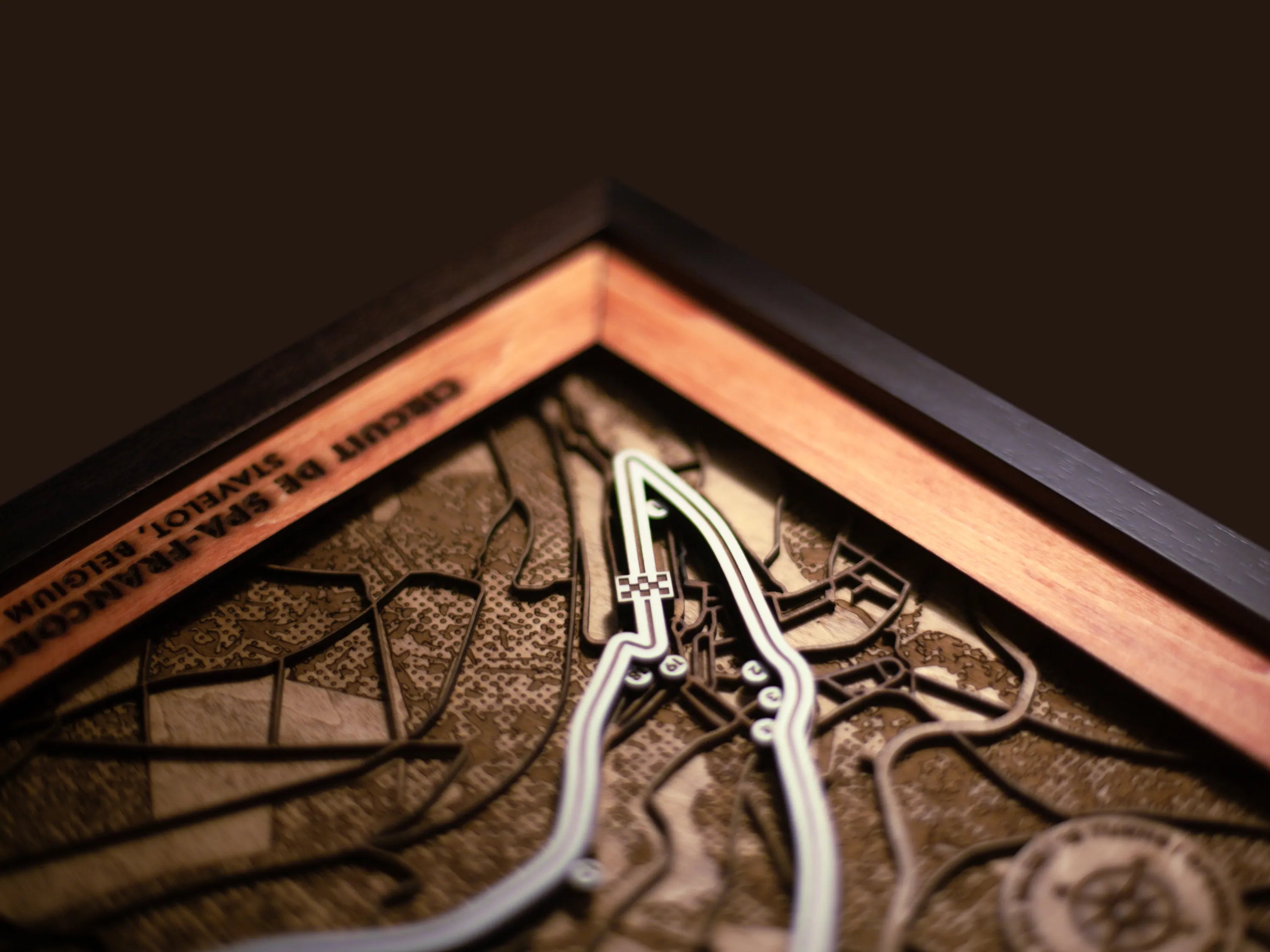 Close-up of the handcrafted layered wood construction and fine details of the Circuit de Spa-Francorchamps wall art.