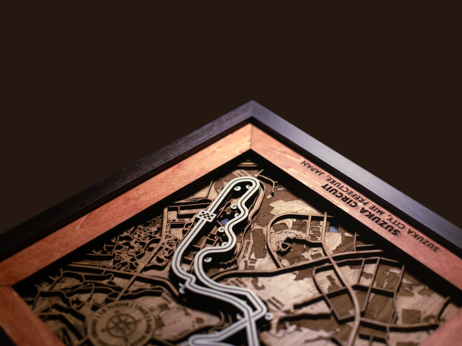 Close-up of the handcrafted layered wood construction and fine details of the Suzuka Circuit wall art.