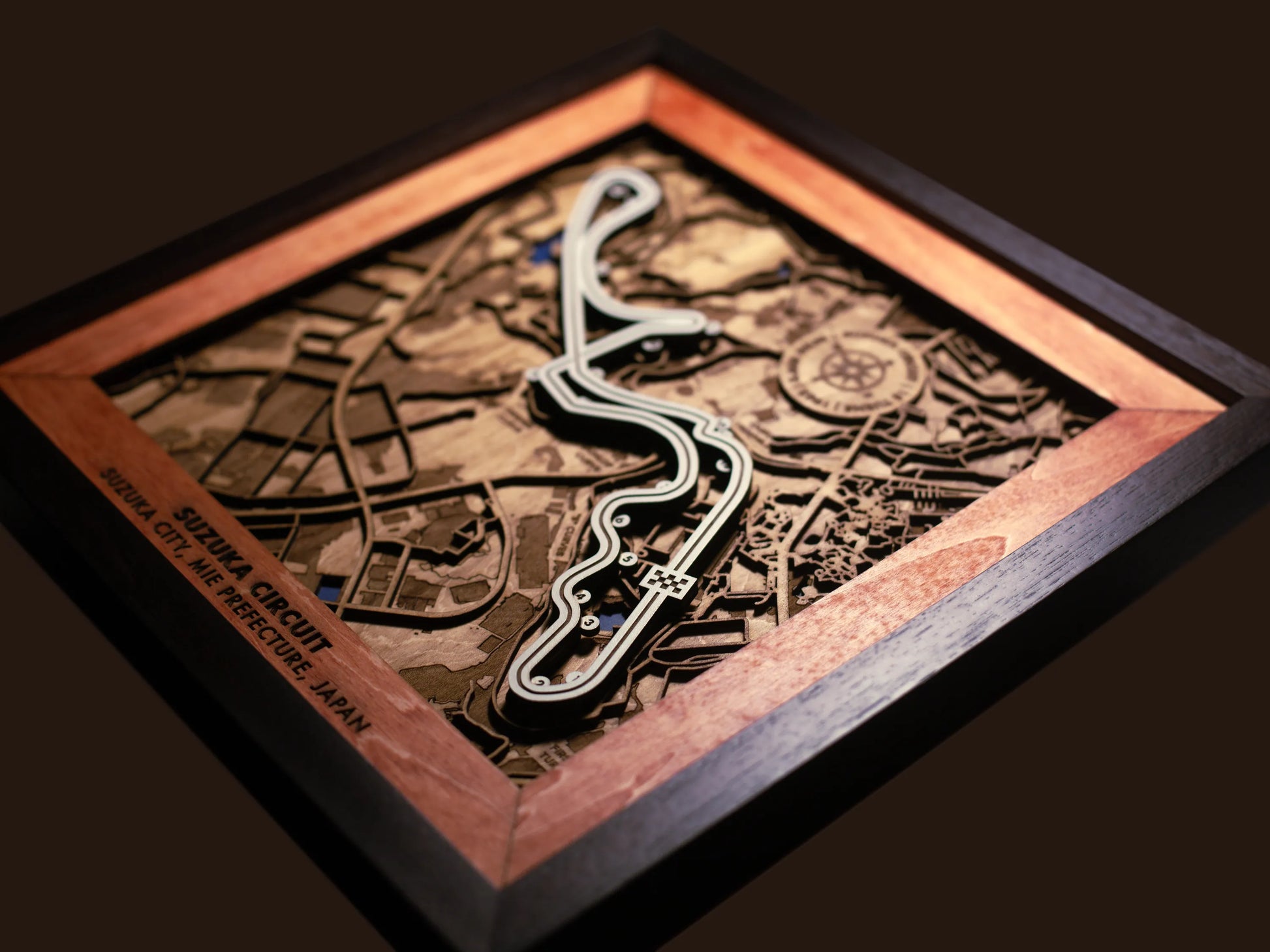 Close-up of the handcrafted layered wood construction and fine details of the Suzuka Circuit wall art.