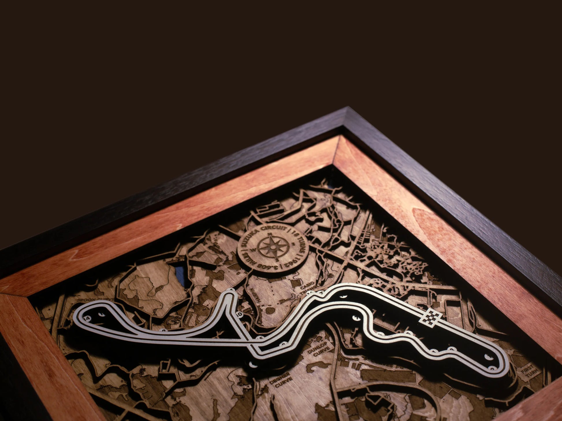 Close-up of the handcrafted layered wood construction and fine details of the Suzuka Circuit wall art.