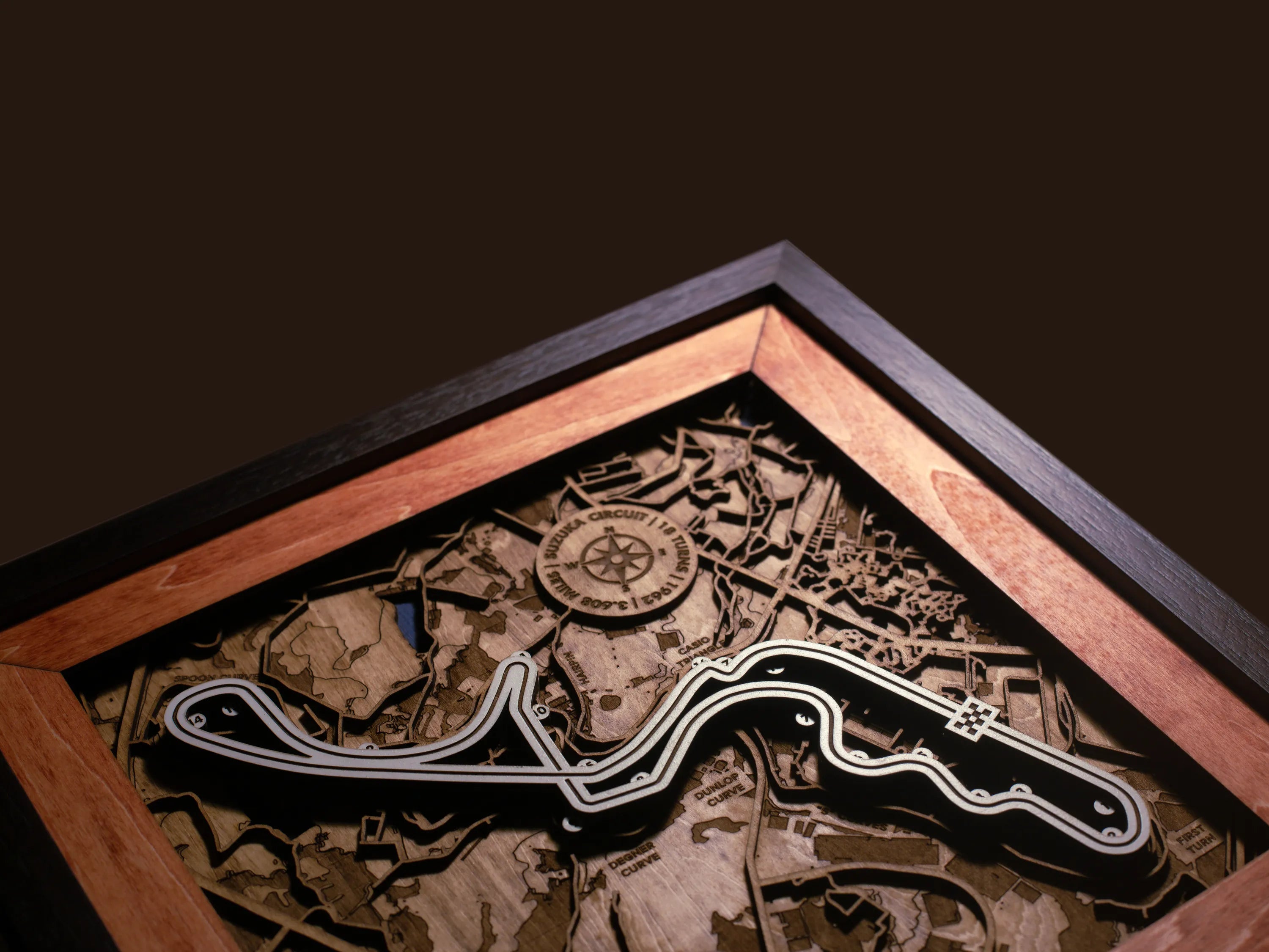 Close-up of the handcrafted layered wood construction and fine details of the Suzuka Circuit wall art.