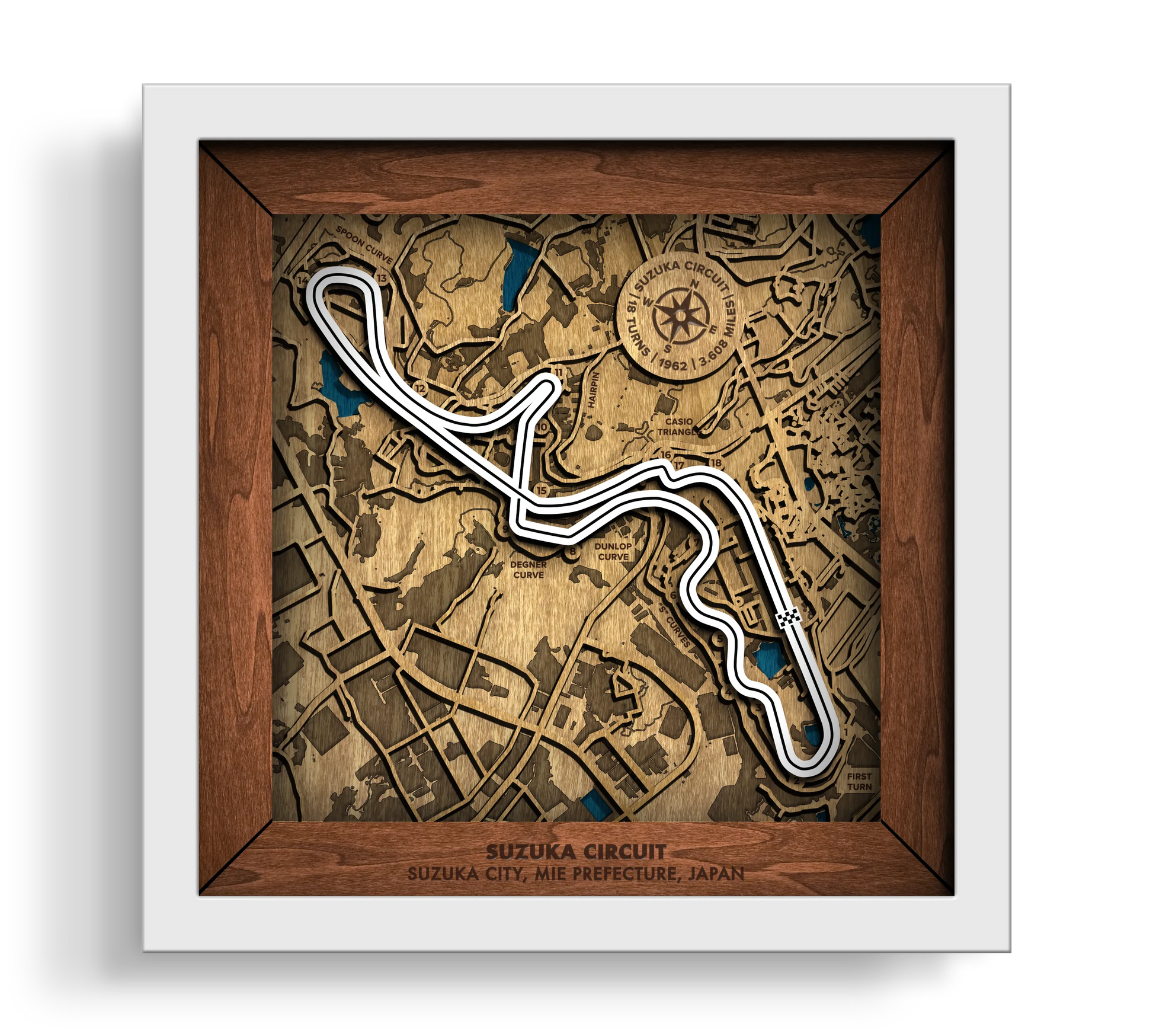 Handcrafted Suzuka Circuit layered wooden racetrack wall art in a white frame.