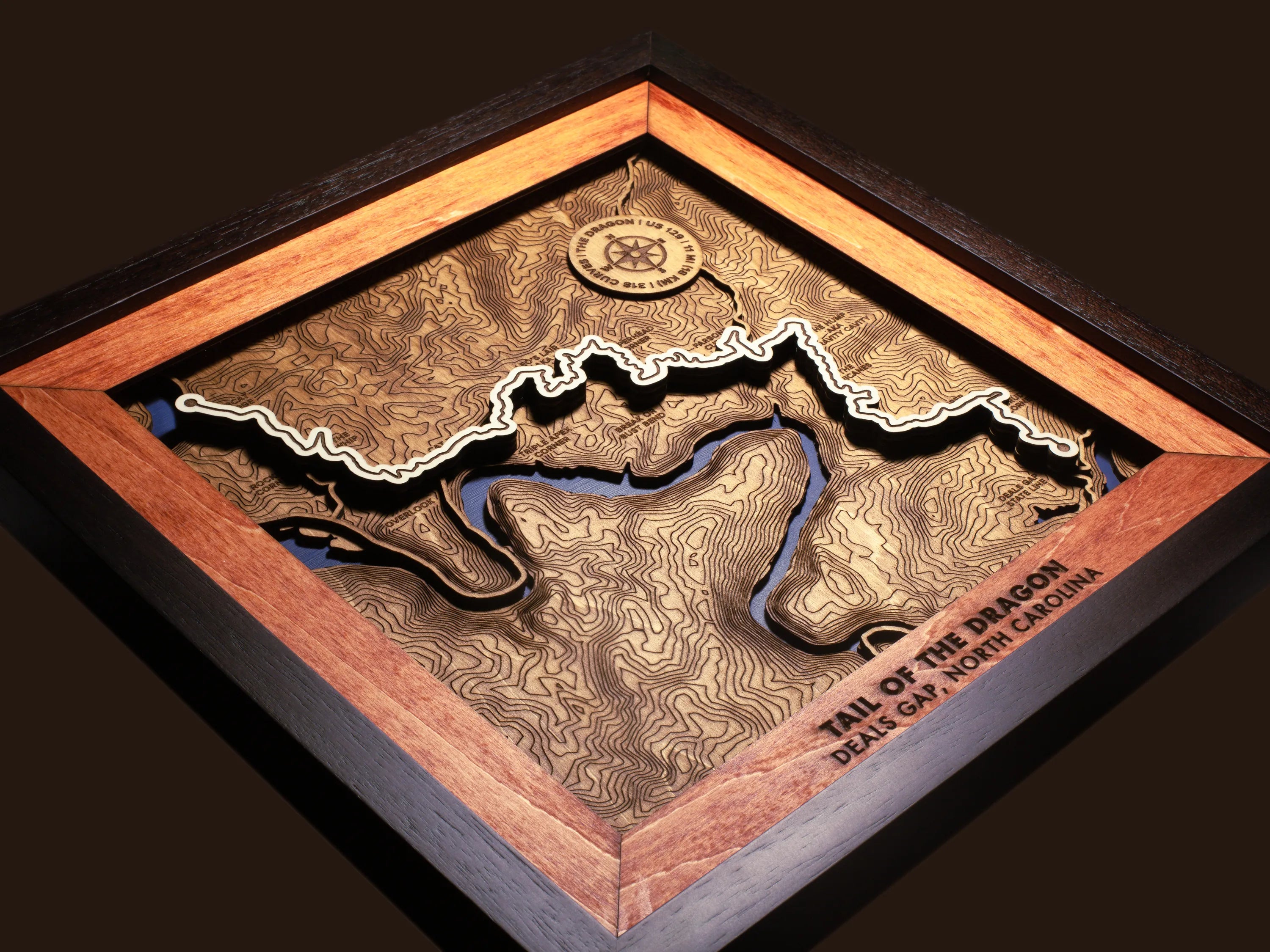 Close-up of the handcrafted layered wood construction and fine details of the Tail of the Dragon wall art.