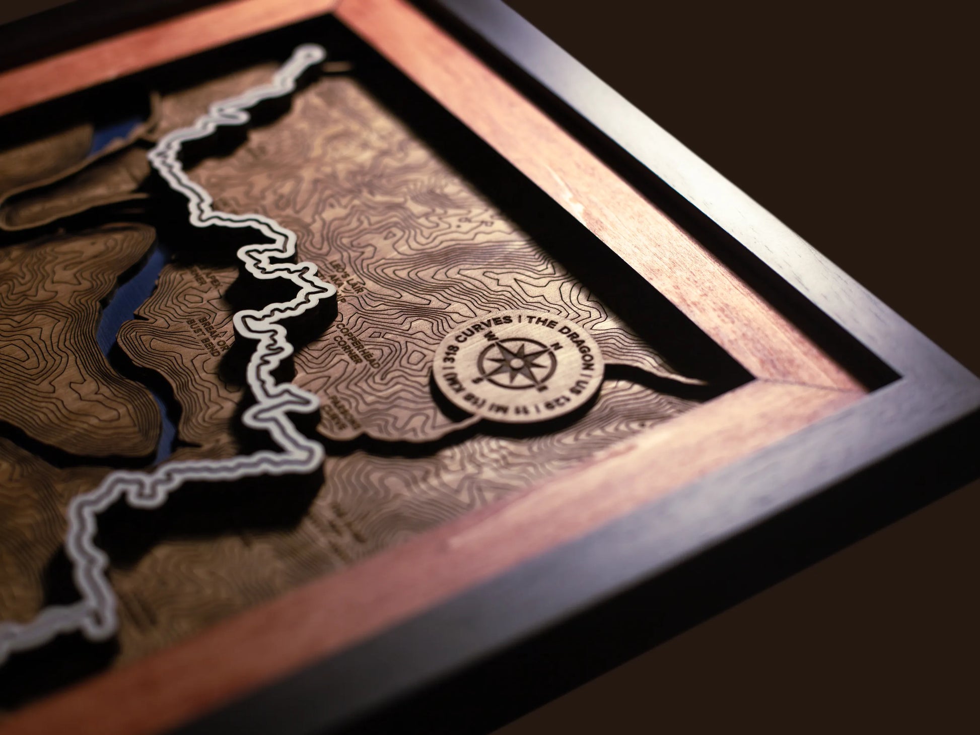 Close-up of the handcrafted layered wood construction and fine details of the Tail of the Dragon wall art.