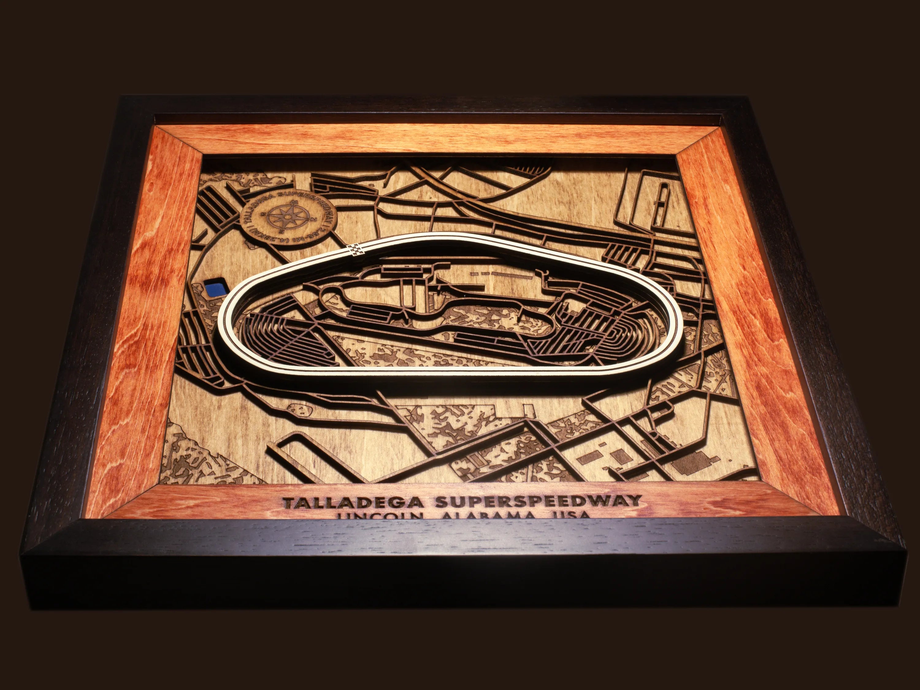Close-up of the handcrafted layered wood construction and fine details of the Talladega Superspeedway wall art.