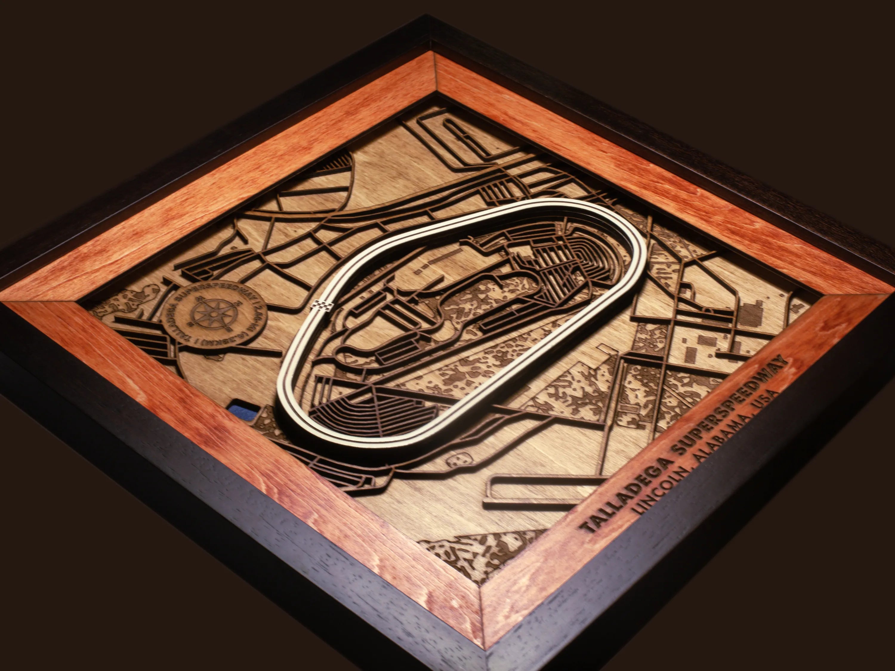 Close-up of the handcrafted layered wood construction and fine details of the Talladega Superspeedway wall art.
