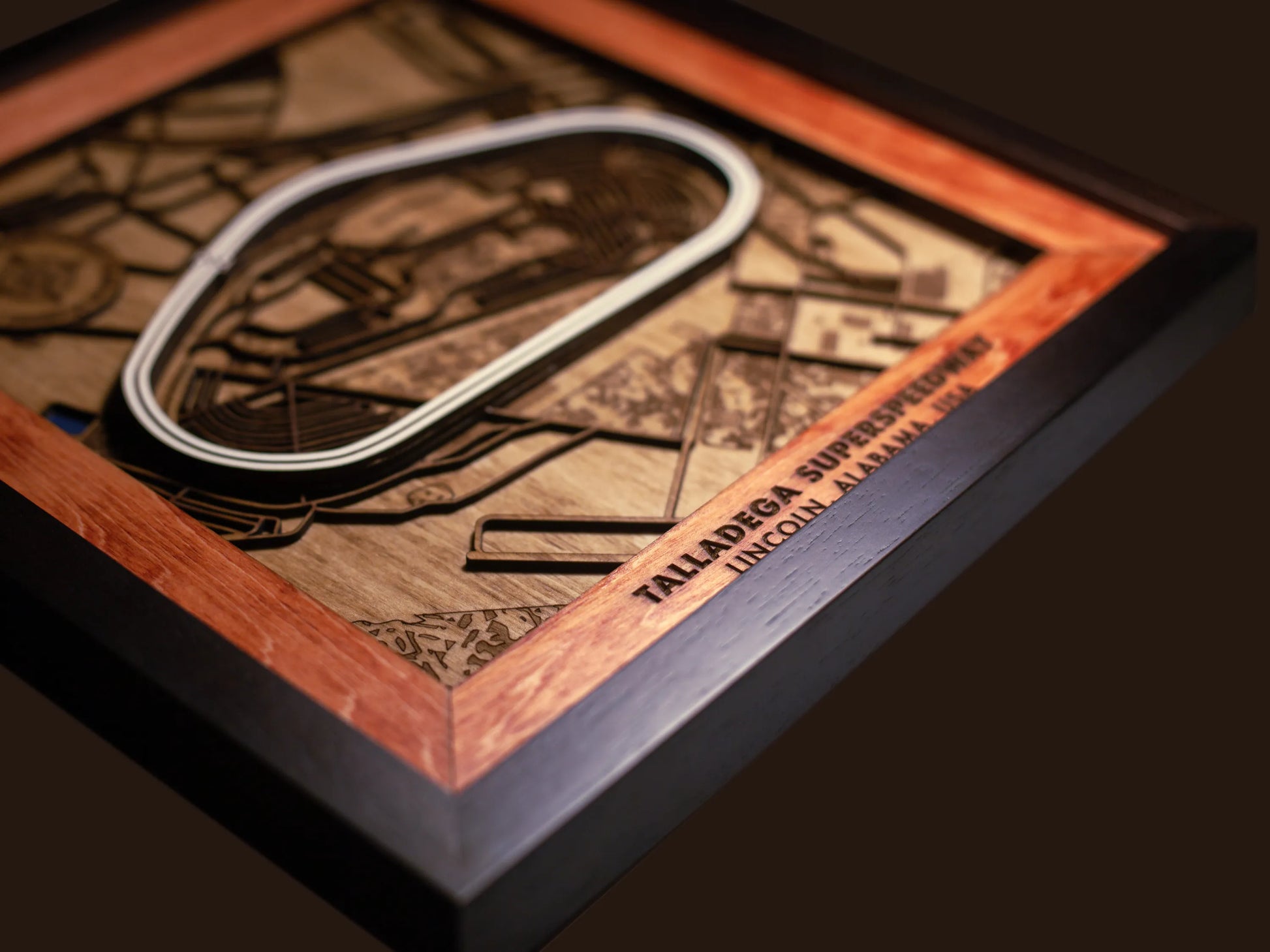 Close-up of the handcrafted layered wood construction and fine details of the Talladega Superspeedway wall art.