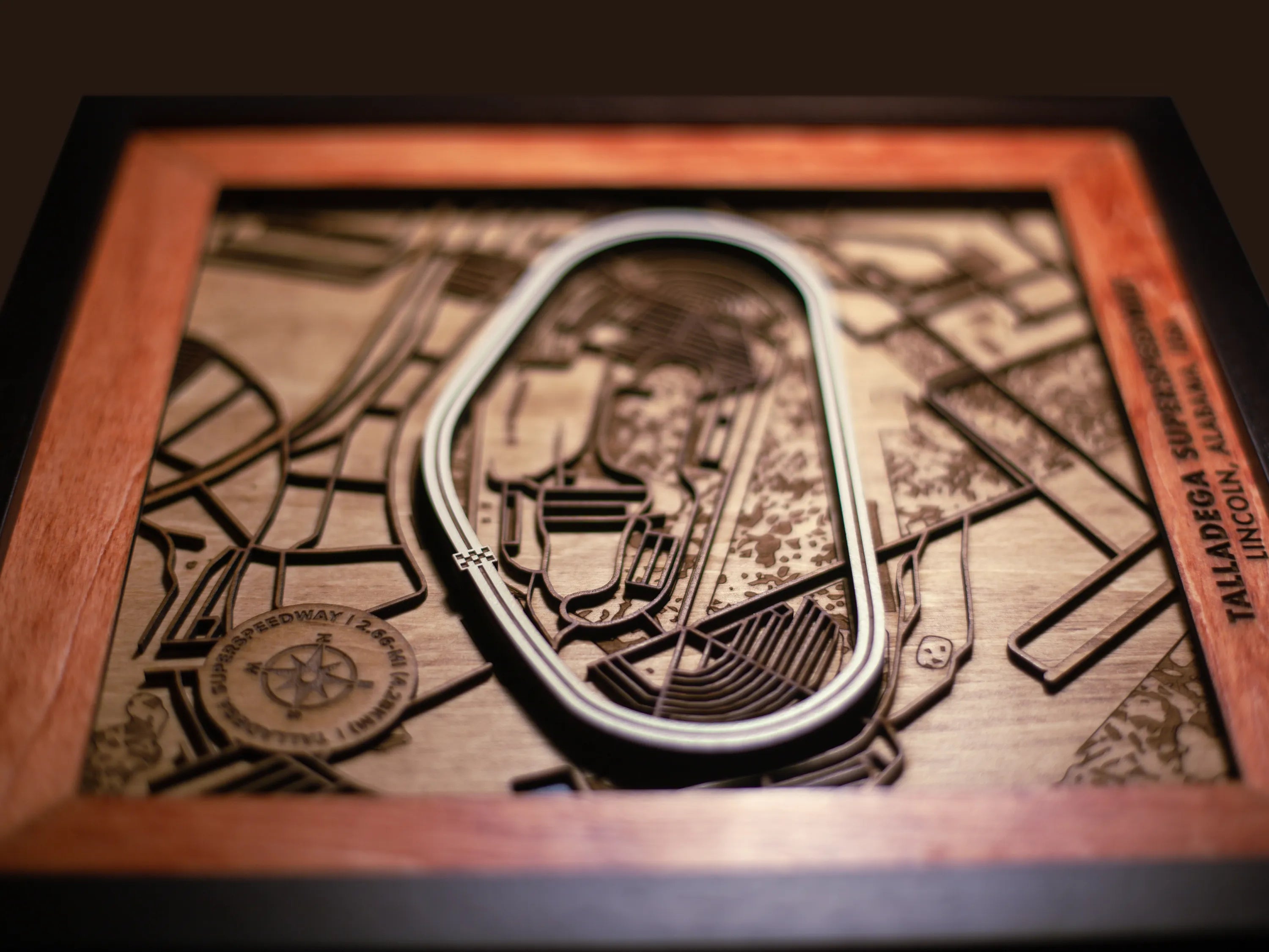 Close-up of the handcrafted layered wood construction and fine details of the Talladega Superspeedway wall art.