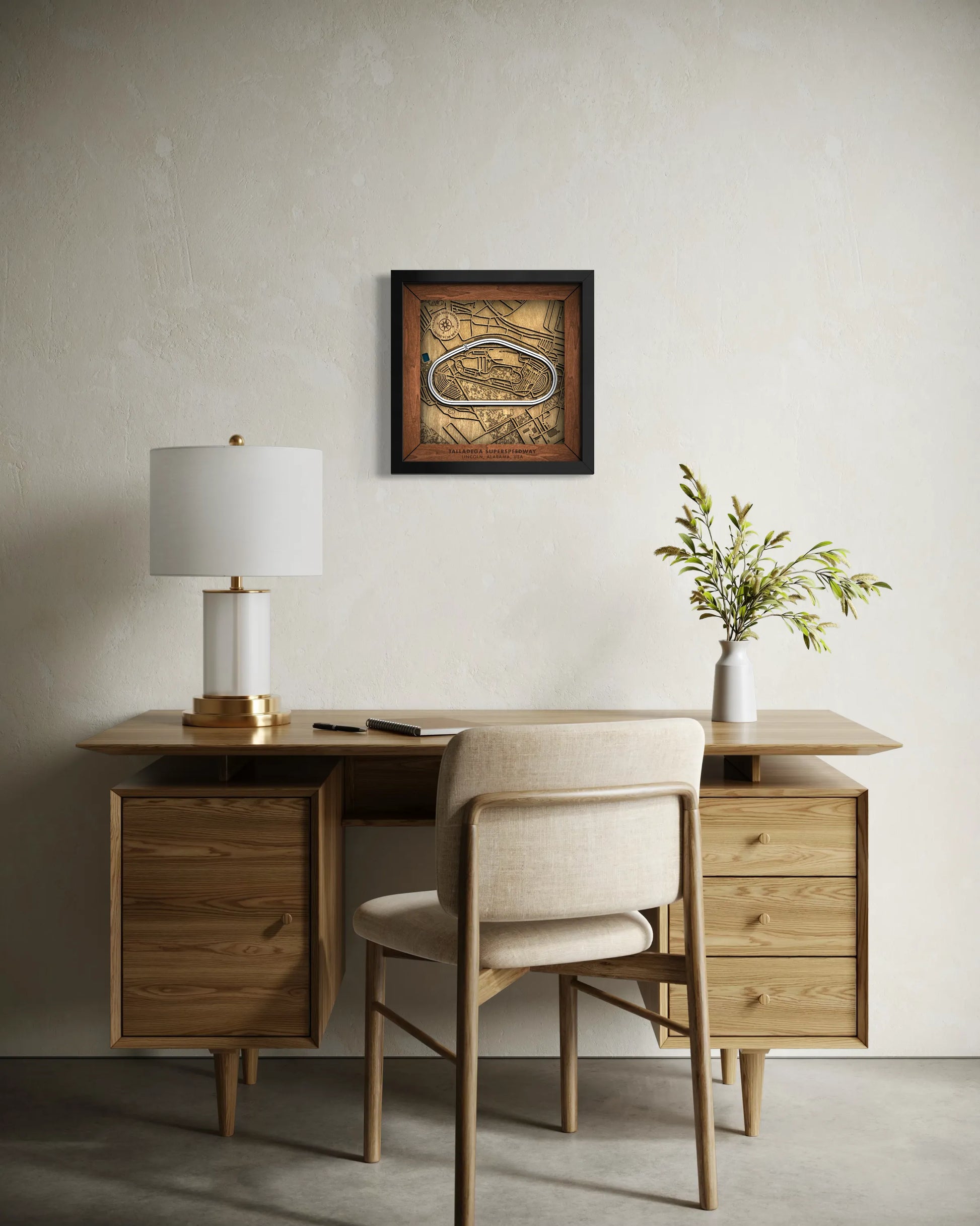 Handcrafted Talladega Superspeedway layered wooden racetrack wall art displayed in a modern living room.