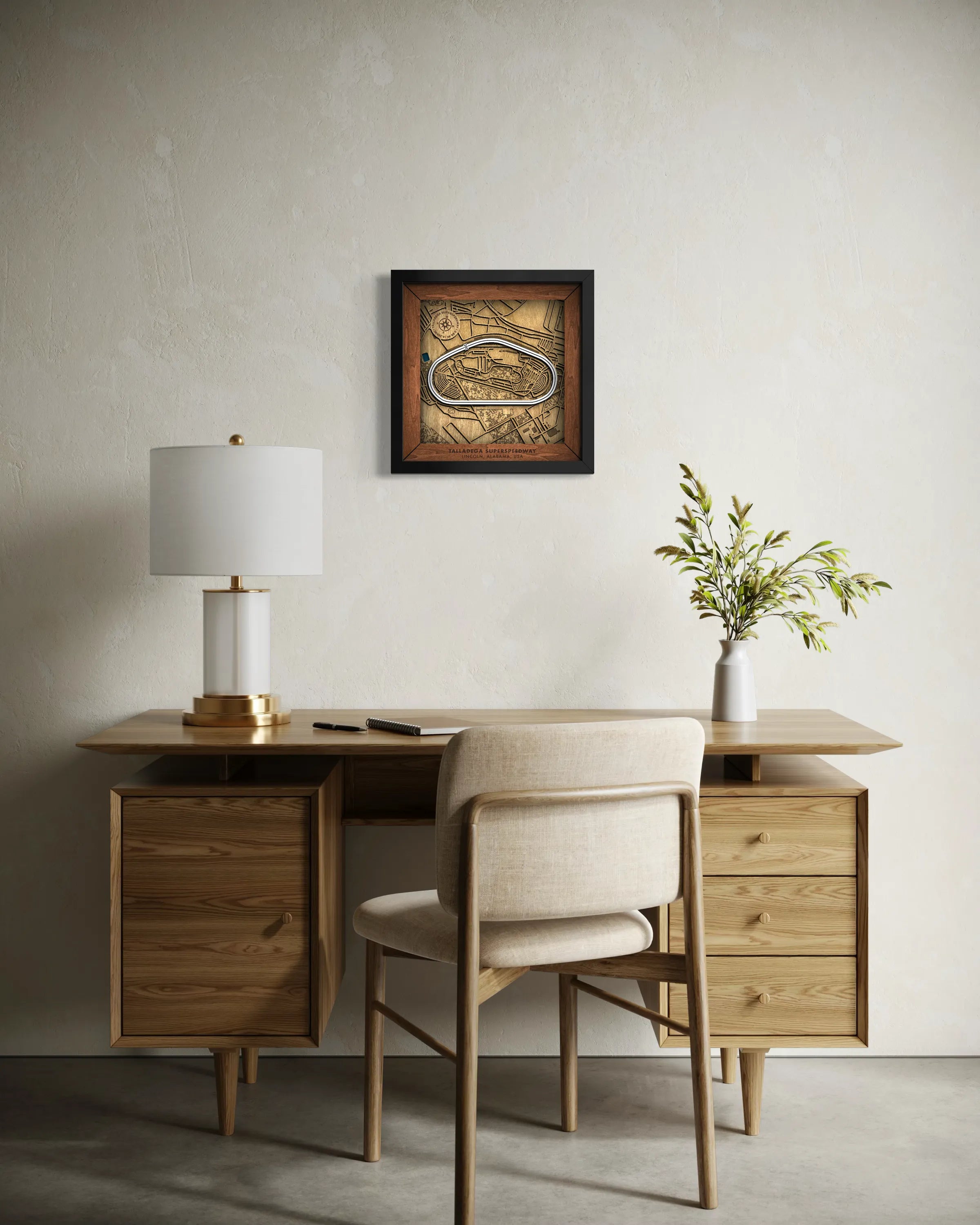 Handcrafted Talladega Superspeedway layered wooden racetrack wall art displayed in a modern living room.