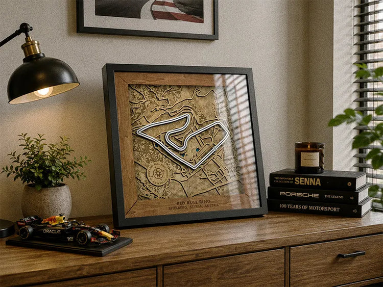 Framed map on a wooden surface with decor items in a room.