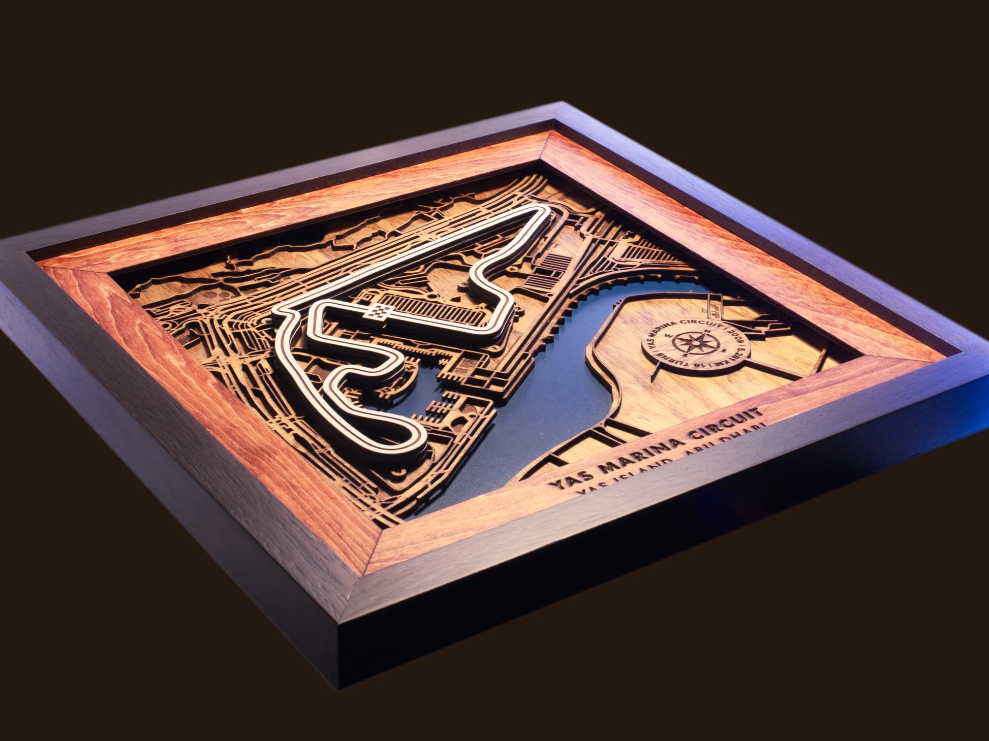 Close-up of the handcrafted layered wood construction and fine details of the Yas Marina Circuit wall art.