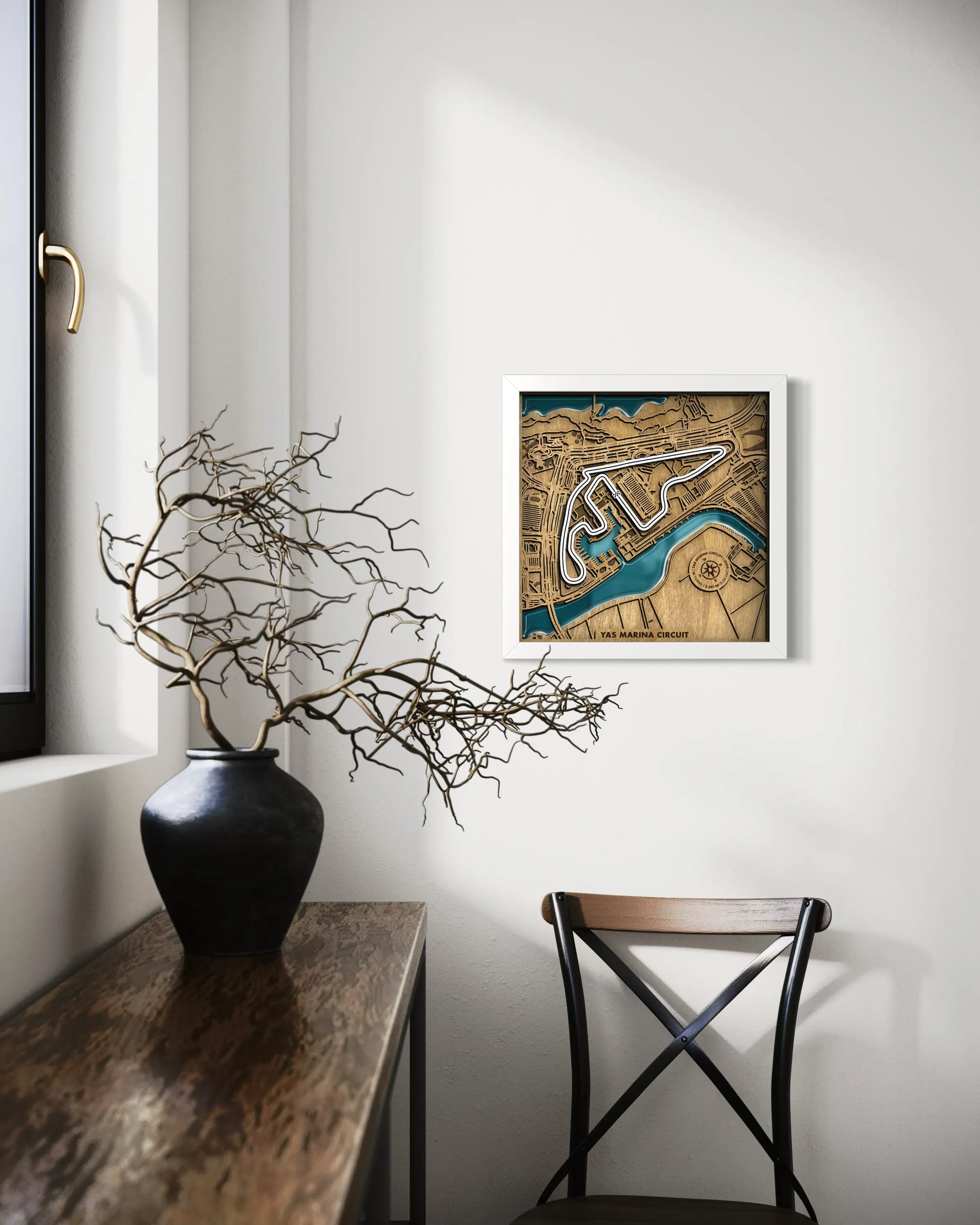 Handcrafted Yas Marina Circuit layered wooden racetrack wall art with epoxy resin waters displayed in a modern living room with a white frame